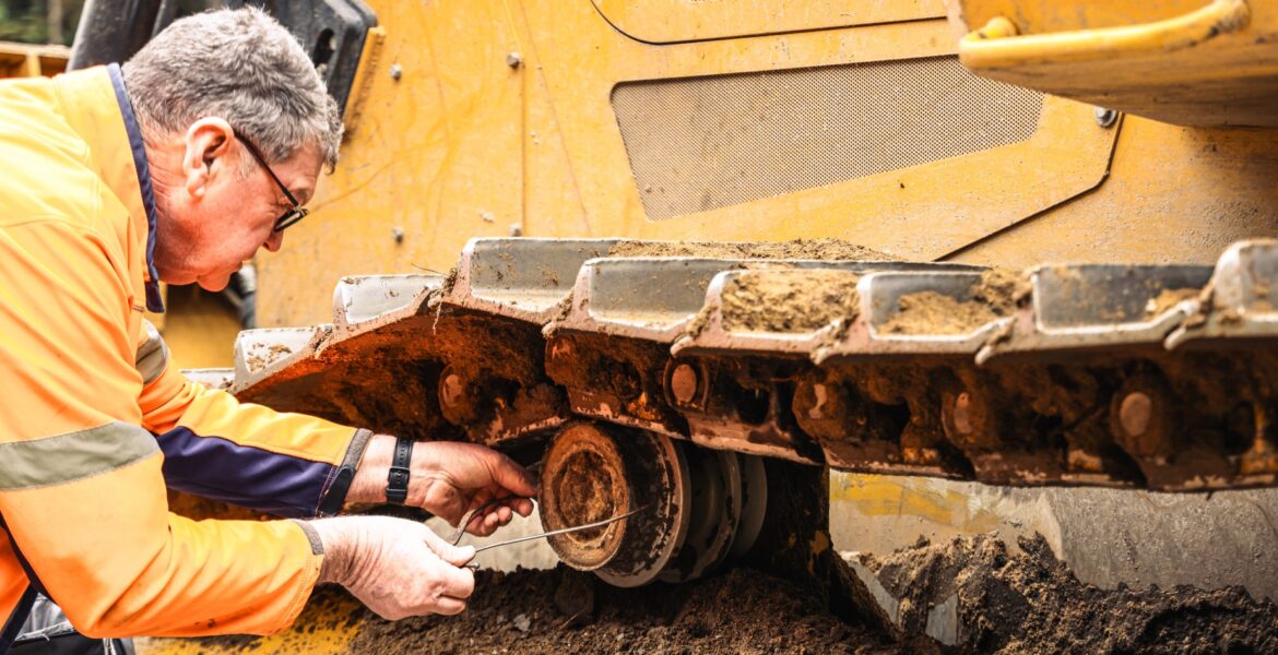 West-Trak technician performing track wear measurement on site.