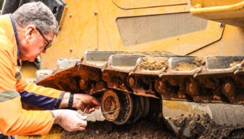 West-Trak technician performing track wear measurement on site.